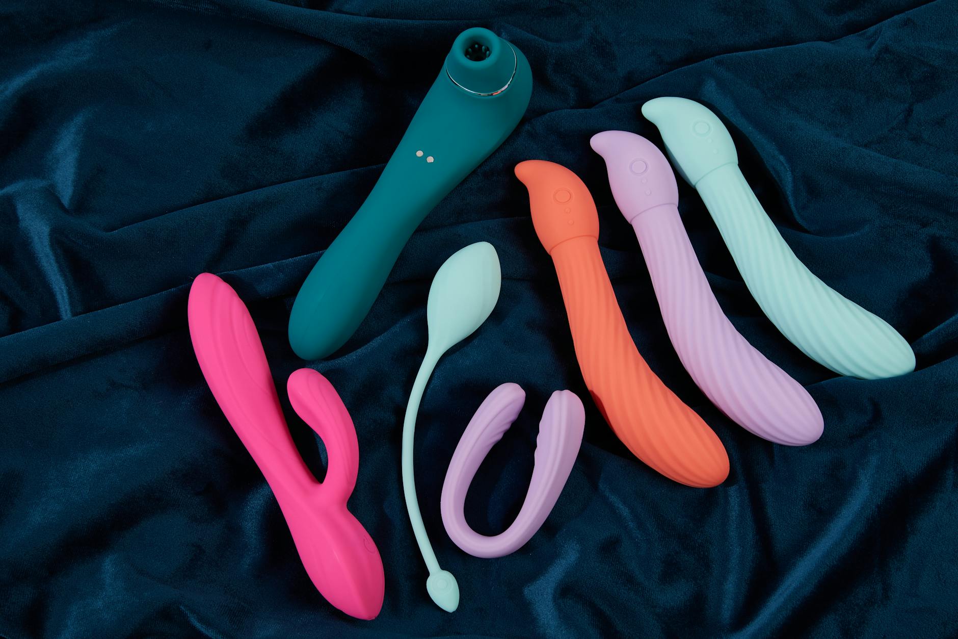 Fresh lemon halves on a pink background in natural sunlight, symbolizing the bright, sustained energy of lemon vibrators
