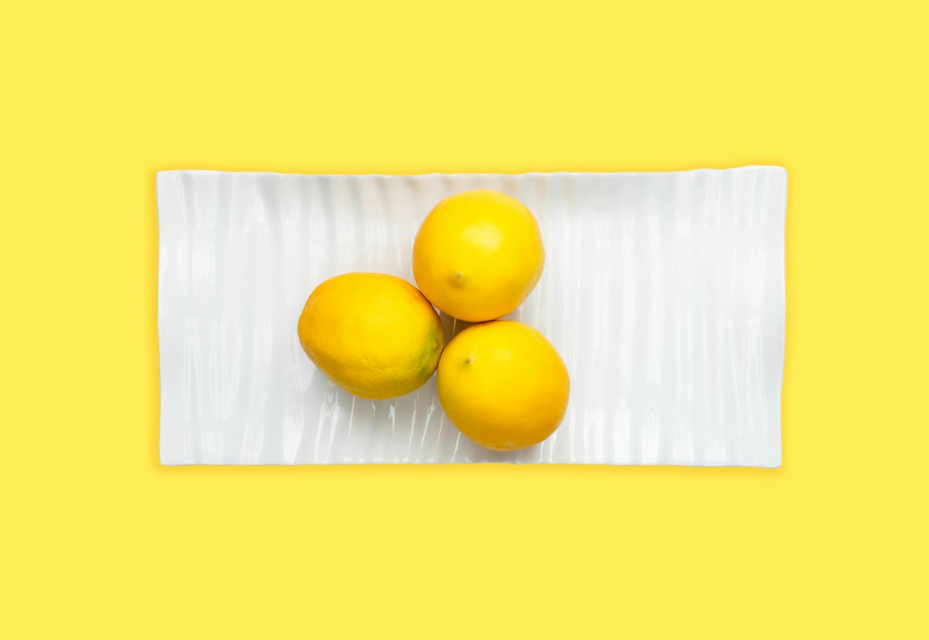 Fresh lemons on a plate symbolizing sensitivity and delicate touch