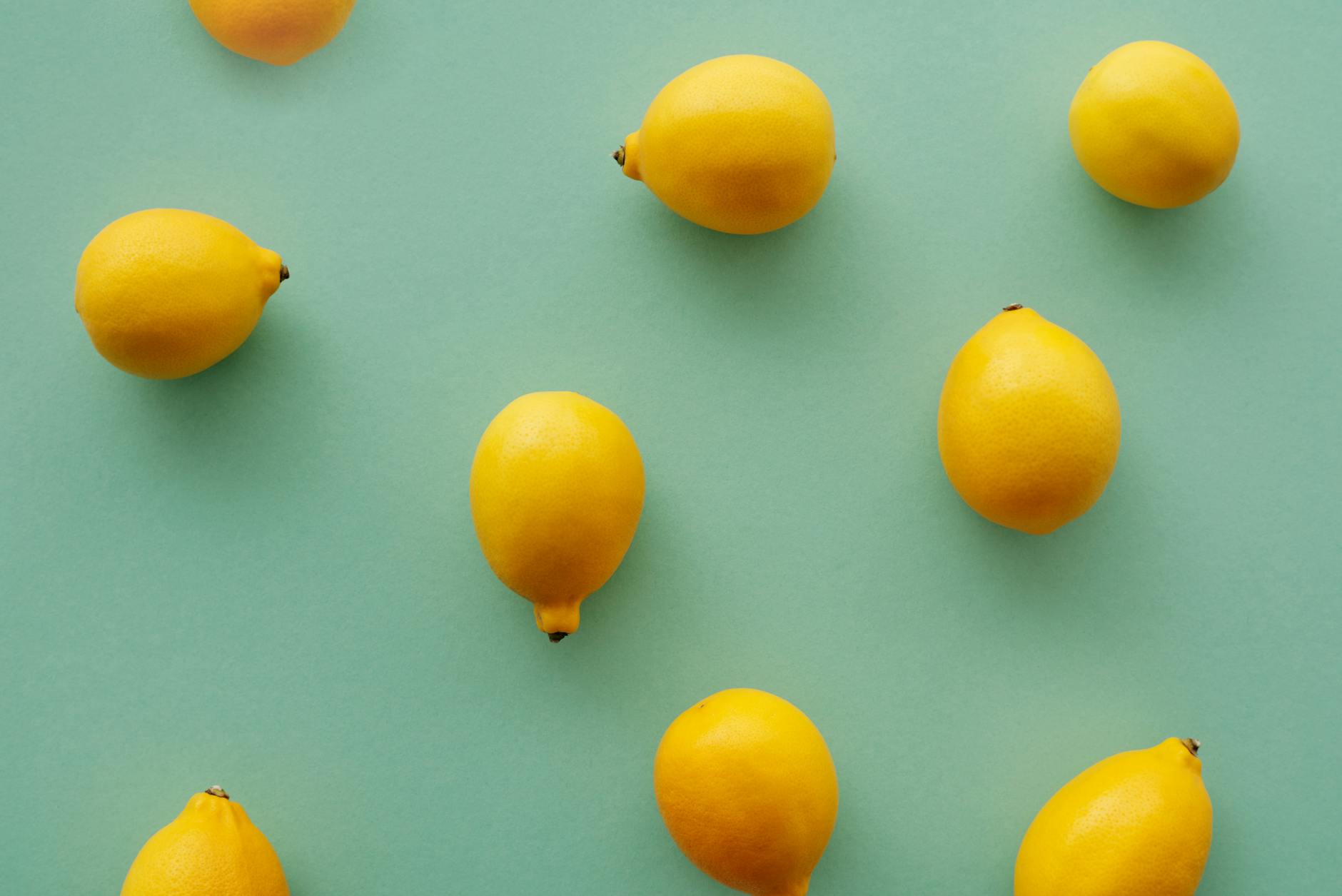 Fresh yellow lemons arranged on a soft green background, symbolizing renewal and reconnection