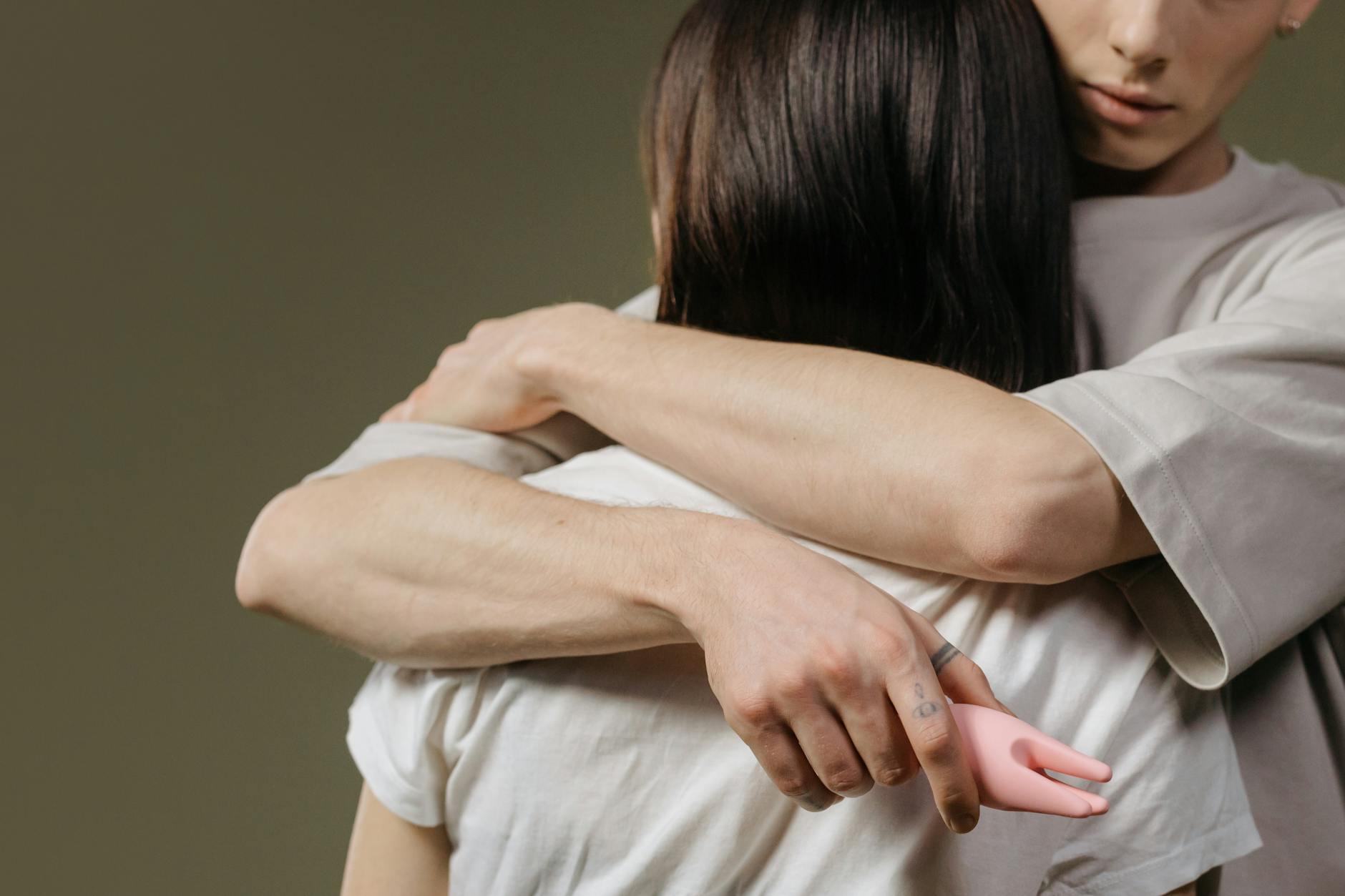 Close-up of a couple embracing in bed, showing intimacy and connection during recovery.
