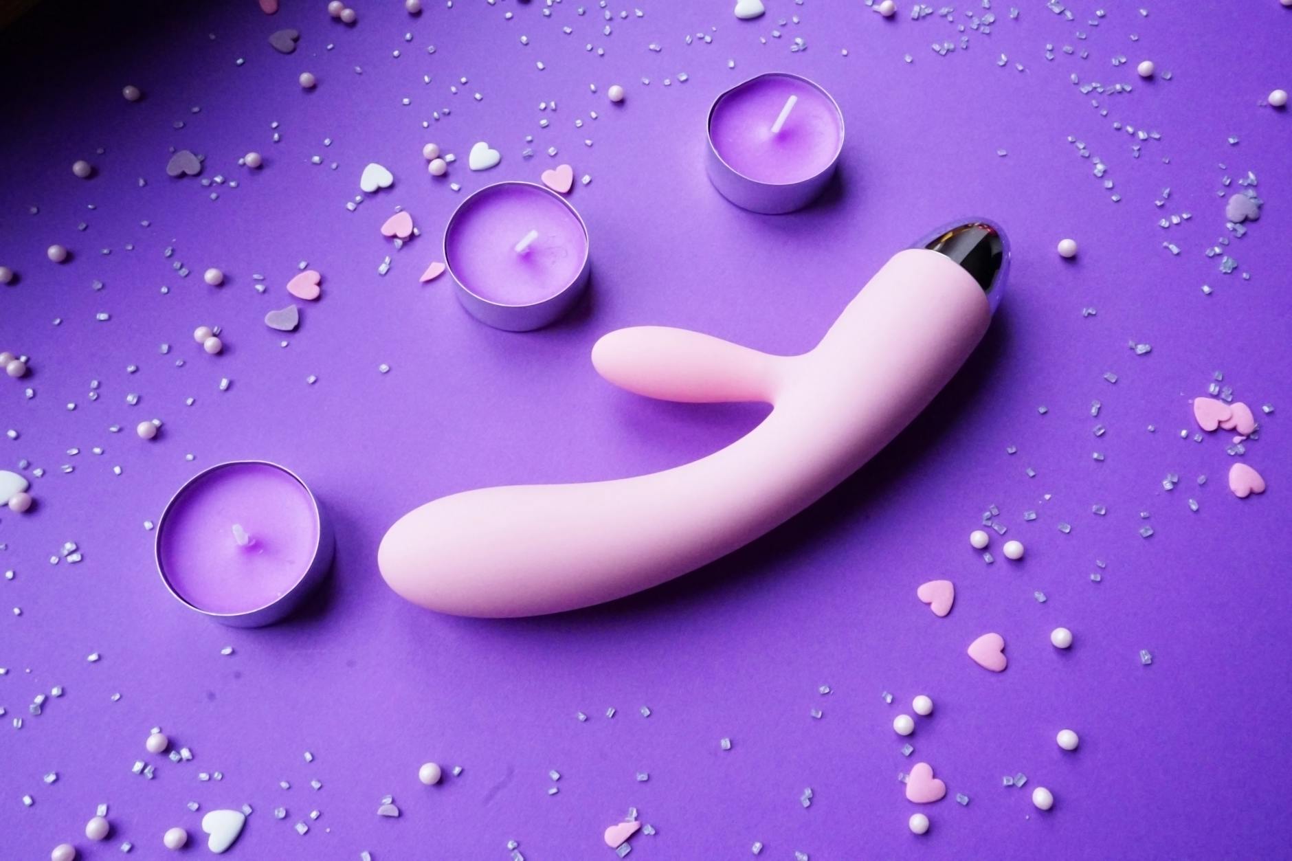 Close-up of colorful silicone adult toys arranged together, showcasing different vibrator styles and designs